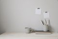 Office table. Empty desk with office supplies and beige wall copy space. Pencils holder, notebooks and cup of coffee Royalty Free Stock Photo