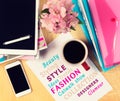 Office table with fashion magazines, digital tablet, smartphone and cup of coffee. View from above Royalty Free Stock Photo