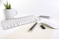 Office table with keyboard, mouse, notebook and smartphone on white background Royalty Free Stock Photo