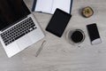 Office table with laptop computer, notebook, digital tablet, pen, smartphone, mouse and coffee on white wood background Royalty Free Stock Photo