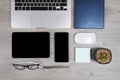 Office table with laptop computer, notebook, digital tablet, pen, smartphone, mouse, eyeglasses and coffee on wood background Royalty Free Stock Photo