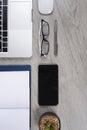 Office table with laptop computer, notebook, digital tablet, pen, smartphone, mouse, eyeglasses and coffee on wood background Royalty Free Stock Photo