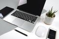 Office table with laptop computer, notebook, digital tablet and smartphone on modern two tone white and grey background Royalty Free Stock Photo