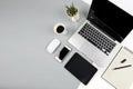 Office table with laptop computer, notebook, digital tablet and smartphone on modern two tone white and grey background Royalty Free Stock Photo