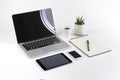 Office table with laptop computer, notebook, digital tablet and smartphone on white background Royalty Free Stock Photo