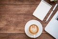 Office table with notebook, computer keyboard, mouse, cup of coffee, tablet pc and smartphone, Top view with copy space Royalty Free Stock Photo