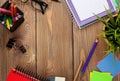 Office table with notepad, colorful pencils, supplies and flower