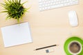 Office table with notepad, computer, coffee cup and flower Royalty Free Stock Photo