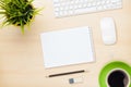 Office table with notepad, computer and coffee cup