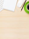 Office table with notepad, computer and coffee cup