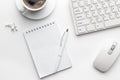 Office table with notepad, computer and coffee cup