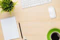 Office table with notepad, computer, flower and coffee cup Royalty Free Stock Photo