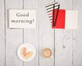 Office table with notepads and text & x22;Good morning!& x22;, cup of coffee and waffles Royalty Free Stock Photo