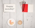 Office table with notepads and text & x22;Happy monday!& x22;, cup of coffee and waffles Royalty Free Stock Photo