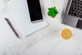 Office table overhead with notebook, computer keyboard and smartphone on coffee cup Royalty Free Stock Photo