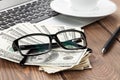 Office table with pc, coffee cup and glasses over money cash Royalty Free Stock Photo