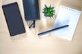 Office table. Smartphone, glasses in a case, notebook and pen decorative cactus. Wooden table.