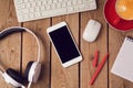 Office table with smartphone and headphones. Business workplace or workspace concept.