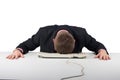 Exhausted businessman falling asleep at his office desk isolated on white Royalty Free Stock Photo