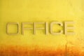 Office text sign on yellow grunge cement wall Royalty Free Stock Photo