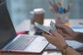 Office woman paying money with credit cart in hand with computer laptop in background