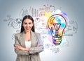 Businesswoman with arms crossed, colourful lightbulb sketch on b Royalty Free Stock Photo