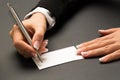 Office woman is writing with the pen on a blank white card Royalty Free Stock Photo