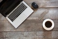 Office wooden desk table with laptop and cup of black coffee. Top view with copy space. Royalty Free Stock Photo