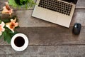 Office wooden desk table with laptop, flower and cup of black coffee. Top view with copy space. Royalty Free Stock Photo