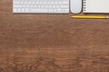 Office wooden table with notebook, yellow pencil, keyboard, and Royalty Free Stock Photo