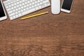 Office wooden table with yellow pencil, tablet, keyboard, mouse Royalty Free Stock Photo