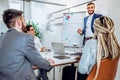 Office work.Handsome young businessman is making presentation for his colleagues