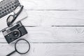 Office work space with camera, notebook, eyepieces, and pen. On a wooden surface. Top view. Royalty Free Stock Photo