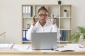 Female office worker having problem due to error on her laptop computer in the office Royalty Free Stock Photo