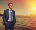 Office worker on the beach during sunset. Royalty Free Stock Photo