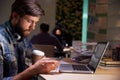 Office Worker With Coffee At Desk Working Late On Laptop Royalty Free Stock Photo