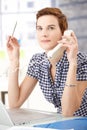 Office worker concentrating on phone call