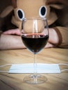 Office worker in cosplay costume of a cow. Guy in the funny animal pyjamas near the a glass of wine. Alcoholic addict, Lost job,