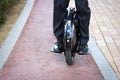 An office worker is driving on an electric mono wheel, side view