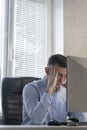 Office worker gets nervous during serious work. Young man is concentrating on a project. Young man in office