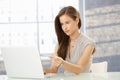 Office worker girl reading on screen