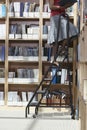 Office Worker On Ladder In File Storage Room