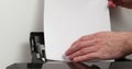 office worker loading paper into printer