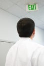 Office worker looking at exit sign Royalty Free Stock Photo