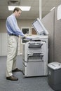 Office worker photocopying Royalty Free Stock Photo