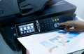 Office worker prints paper on multifunction laser printer. Copy, print, scan, and fax machine in office. Document and paper work. Royalty Free Stock Photo