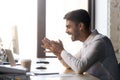 Office worker reading received message looking at computer feels happy