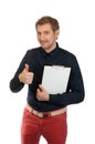 An office worker with red hair shows a thumbs up and in the other hand holds a folder Royalty Free Stock Photo