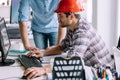 Office worker is reviewing the plans on his computer Royalty Free Stock Photo