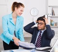 Office worker shocked by stack of papers Royalty Free Stock Photo